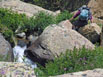 Suzy bouldering up the trail between Lion Lake No 1 and No 2