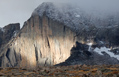 View of the Longs peak Diamond Wall after a stormy night with a spotlight of sunshine highlighting the wall
