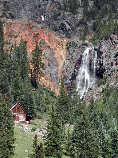 Old mining cabin next to a beautiful waterfall, west of a mining guost town, Animas Forks