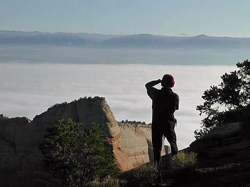 Ben photographing from the camp area with a low cloud covering the ground