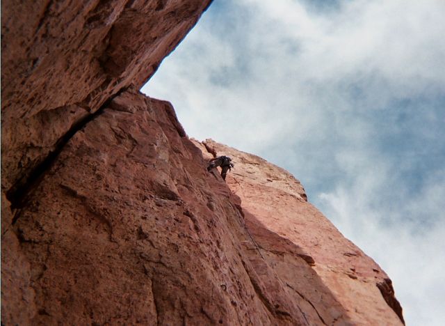 View looking up at Climber at Cactus Cliff, Shelf Road