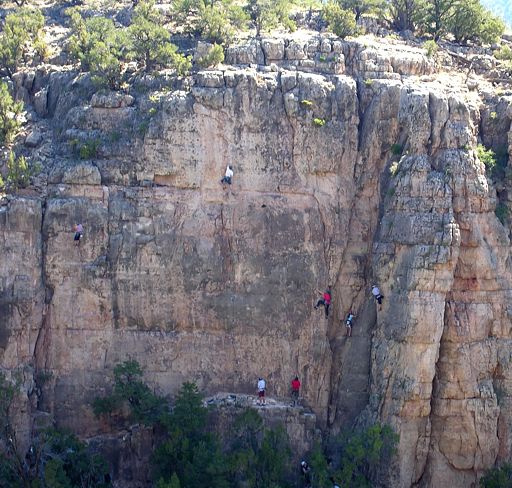 Shaded mornging shot of Menses Prow Proper west side with Memorial Day Weekend climbers scattered about, in the Gallery at Shelf Road
